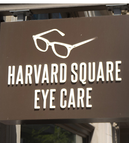 The image shows a sign with the words  HARVARD SQUARE EYE CARE  on it, indicating the name of an eyecare business.
